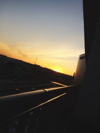 View of airport runway against sky during sunset