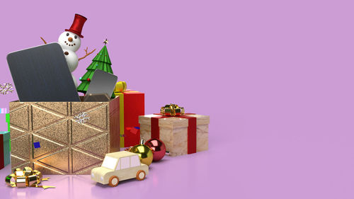Toys in box against colored background