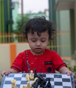 Close-up of boy playing with toy car