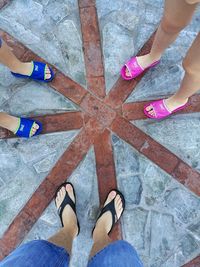 Low section of people standing on tiled floor