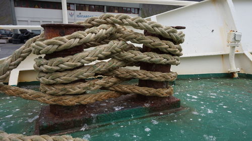 Ropes tied up on bollard in boat