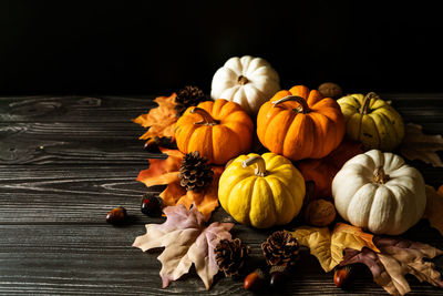 Close-up of pumpkin on table against black background