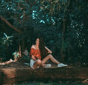 Woman sitting in a forest