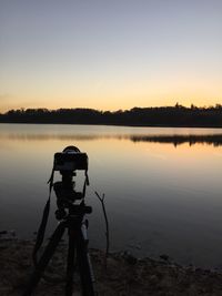 Scenic view of lake against sky during sunset