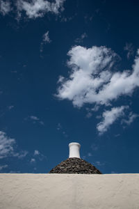 Low angle view of building against cloudy sky