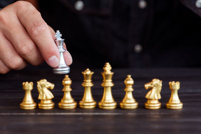 Cropped image of hand holding chess piece