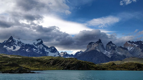 Scenic view of mountains against cloudy sky