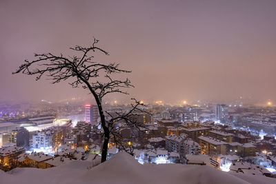 High angle view of illuminated buildings in city at night