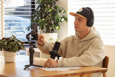 Side view of young woman working at table