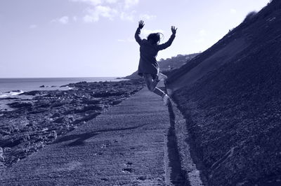 Woman jumping on beach