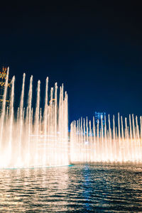 Panoramic view of fountain against clear blue sky