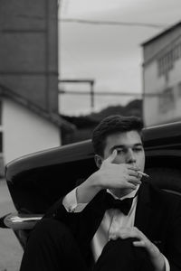 Portrait of young man sitting in car