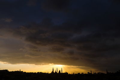 Silhouette of city at sunset