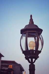 Low angle view of illuminated street light against sky