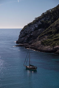 Sailboat on sea against clear sky