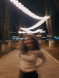 Digital composite image of woman standing at night