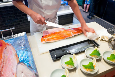 Midsection of man preparing food