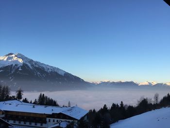 Scenic view of snowcapped mountains against clear blue sky