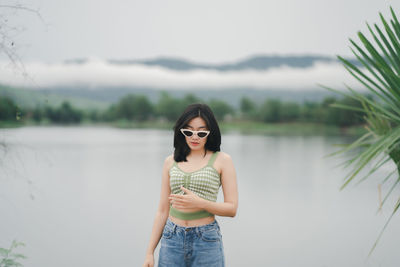 Young woman wearing sunglasses standing outdoors