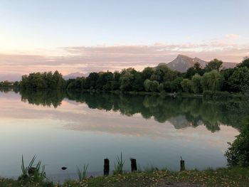 Scenic view of lake against sky at sunset