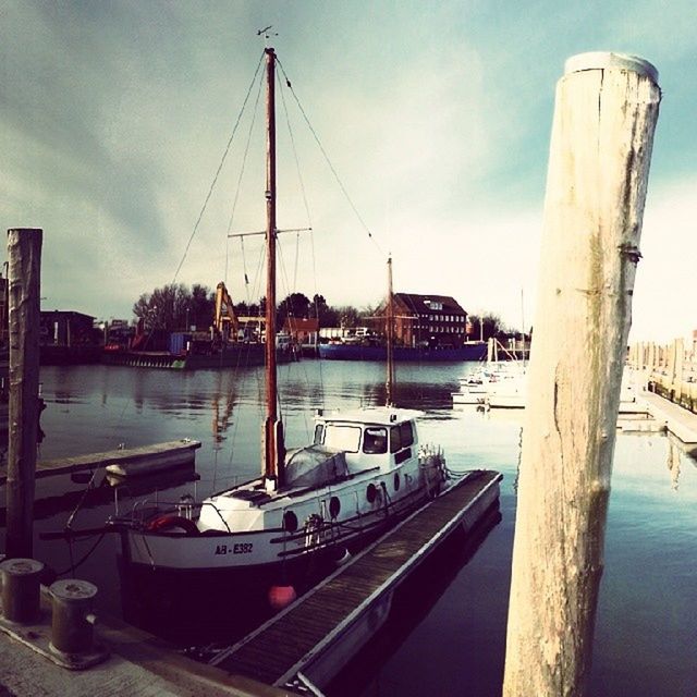 nautical vessel, transportation, moored, mode of transport, boat, water, sky, harbor, built structure, cloud - sky, architecture, mast, sea, river, building exterior, cloud, sailboat, travel, marina, pier