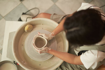 Directly above shot of woman working in clay