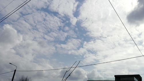 Low angle view of electricity pylon against sky