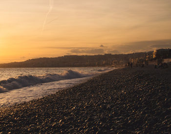 Scenic view of beach against sky during sunset