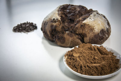 Close-up of chocolate cake on table against white background