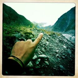 Hand of person on mountain road