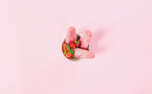 High angle view of pink cake against white background