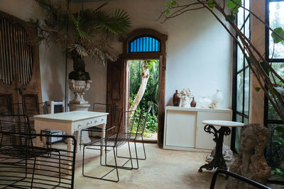 Empty chairs and table against window at home