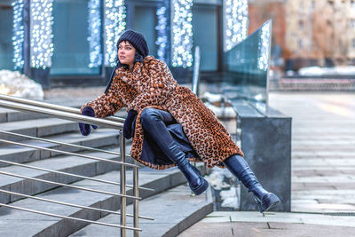 Portrait of woman sitting on staircase