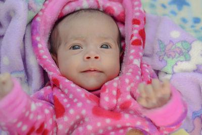 Cute baby girl lying on bed