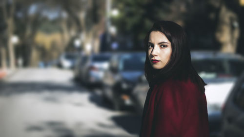 Portrait of young woman standing outdoors