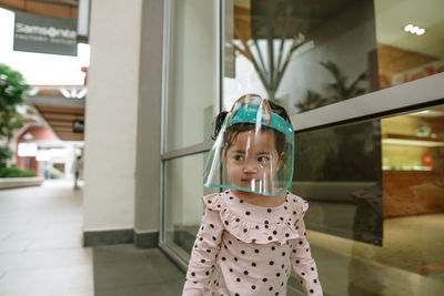 Portrait of cute girl wearing personal protective equipment