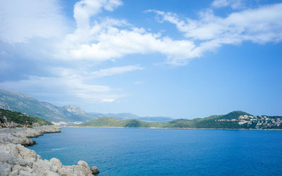 Scenic view of mountains against cloudy sky