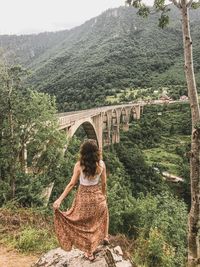 Rear view of woman on bridge