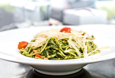 Close-up of cooked noodles with cheese and tomato