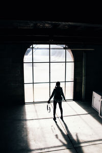 Rear view of man walking in building