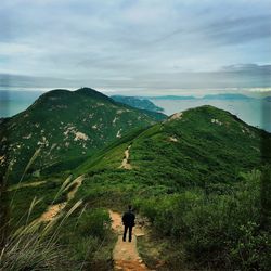 High angle view of man standing trail at mountain against sky