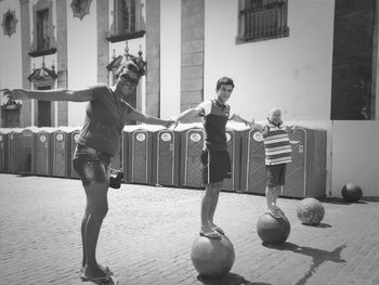 People standing on sphere balls on street
