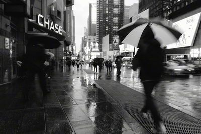 People walking on street in rain