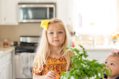 Cute kids preparing food on table at home