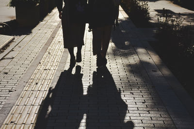 Low section of people walking on footpath