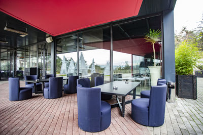 Empty chairs and tables in restaurant