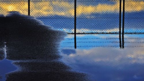 Chainlink fence at sunset