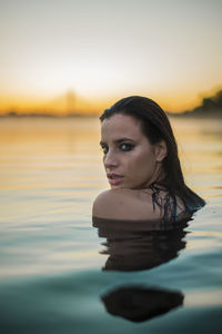 Portrait of beautiful young woman in lake