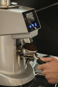 Close-up of hand holding coffee cup