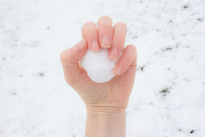 Close-up of human hand holding ice cream